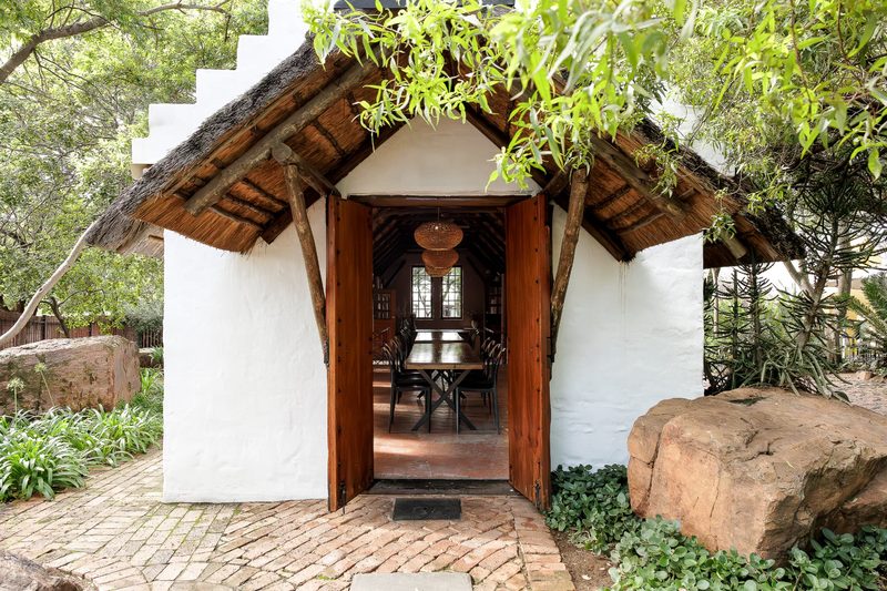 Open timber doors of the Chapel with the set table visible inside